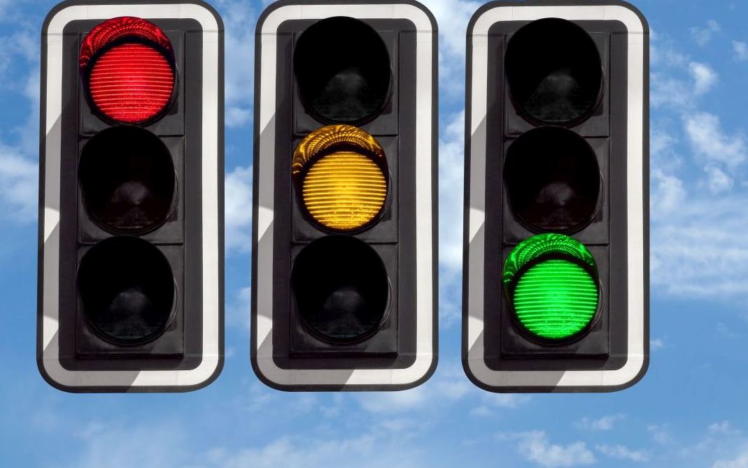 Traffic lights – red yellow green against sky